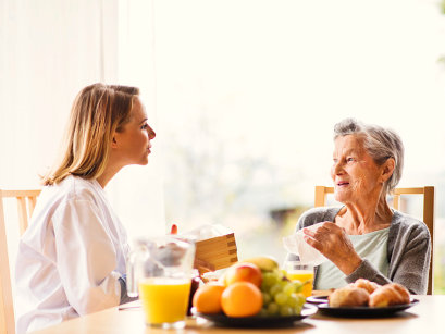 caregiver and a senior woman having a conversation