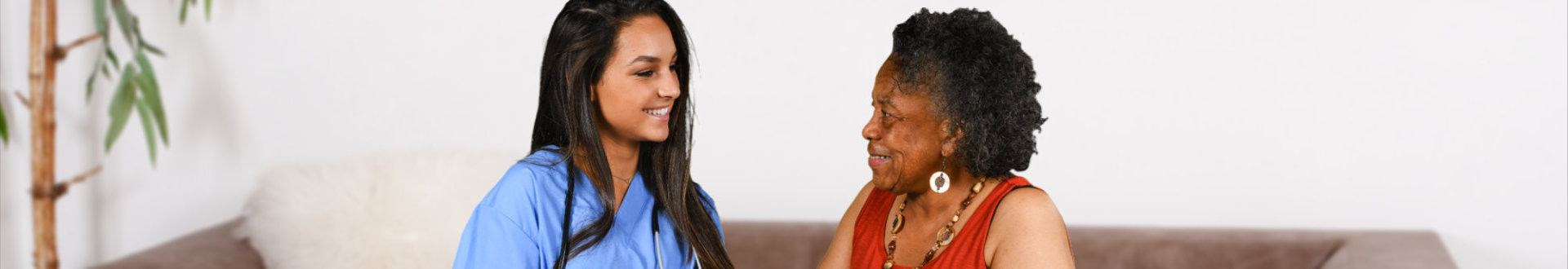 caregiver and a senior woman smiling