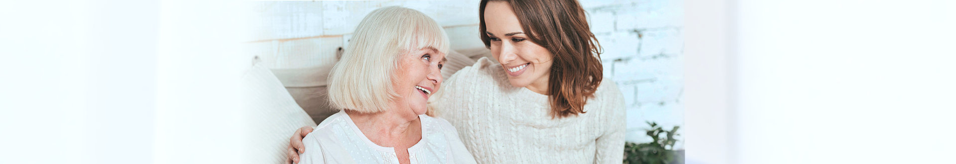 caregiver and senior woman smiling